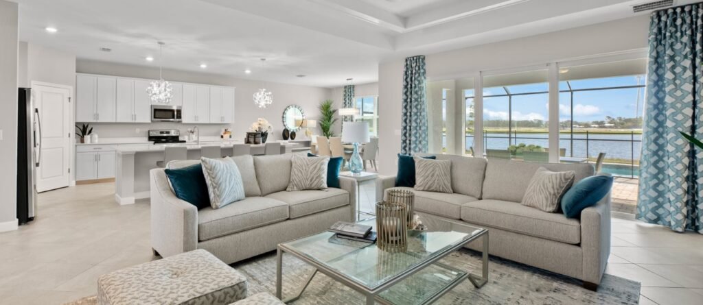 Summerville II open living and dining space with kitchen beyond and lanai views at Valencia Golf & Country Club, Naples, Florida