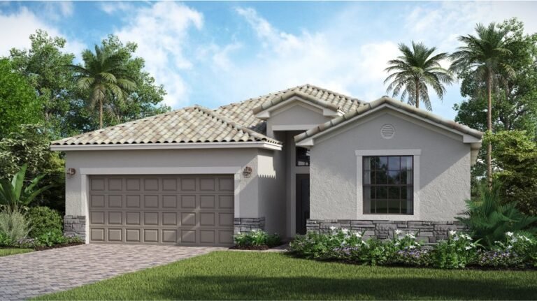 Trevi single-story home exterior with two-car garage and paver driveway at Valencia Golf & Country Club