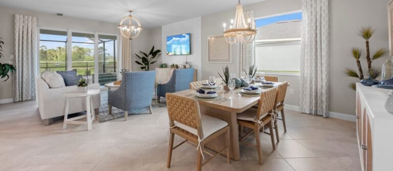 Trevi great room with ceiling fan and sliding doors to the covered lanai at Valencia Golf & Country Club
